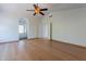 Bedroom boasts hardwood floors, ceiling fan, arched doorway to bathroom, and a closet, creating a serene space at 1416 E Sapium Way, Phoenix, AZ 85048
