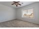 Bedroom with ceiling fan, neutral carpet and walls, and window with blind at 1416 E Sapium Way, Phoenix, AZ 85048