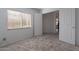 Bedroom featuring neutral carpet, light walls, window, and open door at 1416 E Sapium Way, Phoenix, AZ 85048