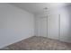 Empty bedroom featuring neutral carpet, white walls, and a sliding door closet at 1416 E Sapium Way, Phoenix, AZ 85048