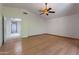 Bedroom with hardwood floors, ceiling fan, vaulted ceilings, and access to the hall and en-suite bath at 1416 E Sapium Way, Phoenix, AZ 85048
