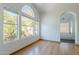 Bedroom with hardwood floors and a large arched window looking out at the vegetation on a nearby rock formation at 1416 E Sapium Way, Phoenix, AZ 85048