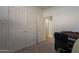 Bedroom with neutral carpet, two doors and a work station at 1416 E Sapium Way, Phoenix, AZ 85048