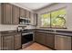 Modern kitchen featuring stainless steel appliances and large windows to enjoy outdoor views at 1416 E Sapium Way, Phoenix, AZ 85048