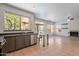 Spacious kitchen with stainless steel appliances and views to fireplace and backyard pool at 1416 E Sapium Way, Phoenix, AZ 85048