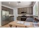 Updated kitchen featuring stainless steel appliances and granite countertops for meal preparation at 1416 E Sapium Way, Phoenix, AZ 85048