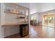 A kitchenette with under counter refrigerator, shelving, and a convenient workspace at 1416 E Sapium Way, Phoenix, AZ 85048