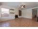 Bright living room featuring tile floors, fireplace, ceiling fan, and dual built-in shelving at 1416 E Sapium Way, Phoenix, AZ 85048