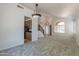 Spacious living room with views to staircase and kitchen with modern lighting fixtures at 1416 E Sapium Way, Phoenix, AZ 85048