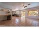 Open living space featuring tile floors, view of the patio and an attached kitchen space at 1416 E Sapium Way, Phoenix, AZ 85048