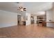 Open concept space featuring tile flooring, a ceiling fan, and views of the kitchen at 1416 E Sapium Way, Phoenix, AZ 85048
