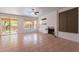 Open living space with tile floors, a fireplace, view of the backyard, and access to the patio at 1416 E Sapium Way, Phoenix, AZ 85048