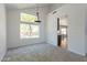 Bright, open living room featuring large windows and neutral carpeting at 1416 E Sapium Way, Phoenix, AZ 85048