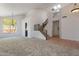 Open-concept living area with staircase and vaulted ceiling at 1416 E Sapium Way, Phoenix, AZ 85048