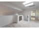 Bright loft area featuring a skylight and neutral carpeting leading to another room with natural light at 1416 E Sapium Way, Phoenix, AZ 85048