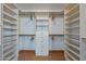 Spacious walk-in closet with built-in shelves, drawers, and hanging rods for optimal organization at 1416 E Sapium Way, Phoenix, AZ 85048