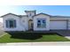 Charming single-story home with a well-manicured lawn and neutral-colored exterior at 21601 W Mariposa St, Buckeye, AZ 85396