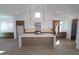 Modern kitchen featuring an island, stainless steel appliances, and white cabinets at 21601 W Mariposa St, Buckeye, AZ 85396