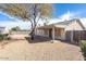 View of the backyard highlighting the covered patio area, desert landscaping, and privacy fencing around the property at 8464 W Royal Blackheath Dr, Arizona City, AZ 85123