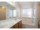 Bathroom featuring a tub/shower combo and a double sink vanity at 8464 W Royal Blackheath Dr, Arizona City, AZ 85123