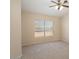 Neutral bedroom with carpet, ceiling fan, and natural lighting at 8464 W Royal Blackheath Dr, Arizona City, AZ 85123