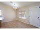 Bright dining area with tile flooring, chandelier, and window with mini blinds at 8464 W Royal Blackheath Dr, Arizona City, AZ 85123