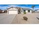 Charming single-story home featuring a two car garage and desert landscaping at 8464 W Royal Blackheath Dr, Arizona City, AZ 85123