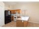 Cozy kitchen with wood cabinets, tile floors, white appliances, and ample counter space at 8464 W Royal Blackheath Dr, Arizona City, AZ 85123