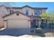 Charming two-story home with a two car garage, beautiful landscaping, and a welcoming front porch at 8953 E Yucca St, Scottsdale, AZ 85260