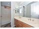 Bathroom with a double sink vanity, shower-tub combo, and lots of mirrors at 32030 N 20Th Ln, Phoenix, AZ 85085