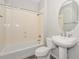 Cozy bathroom showcasing a shower-tub combo, toilet, and pedestal sink with oval mirror at 32030 N 20Th Ln, Phoenix, AZ 85085