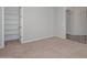 Bedroom with carpet flooring, baseboards, closet, and access to additional rooms at 32030 N 20Th Ln, Phoenix, AZ 85085