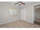 Neutral bedroom with carpet flooring, a ceiling fan, and a double door closet at 32030 N 20Th Ln, Phoenix, AZ 85085