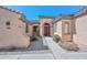 Inviting home facade featuring a well-maintained exterior, arched entrance, and professionally landscaped front yard at 32030 N 20Th Ln, Phoenix, AZ 85085