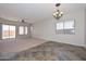 Spacious living room boasting ample natural light, neutral walls, and a decorative ceiling fan at 32030 N 20Th Ln, Phoenix, AZ 85085