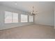 Bright living room with neutral carpet, recessed lighting, and large windows with blinds at 32030 N 20Th Ln, Phoenix, AZ 85085