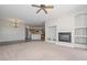 Comfortable living space showcasing a fireplace, carpet, kitchen, and neutral paint at 32030 N 20Th Ln, Phoenix, AZ 85085