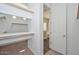 Bright walk-in closet with custom shelving, adjacent to open bathroom with tub at 32030 N 20Th Ln, Phoenix, AZ 85085