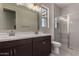 Modern bathroom featuring double sinks, espresso cabinets, and a glass-enclosed shower at 18714 E Panchito Dr, Gold Canyon, AZ 85118