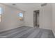 A bright bedroom with gray carpet, a neutral color palette, and doorway to the en suite at 18714 E Panchito Dr, Gold Canyon, AZ 85118