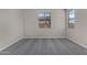 Bright bedroom featuring plush gray carpet and ample natural light from two windows at 18714 E Panchito Dr, Gold Canyon, AZ 85118