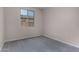 This bedroom features neutral paint, carpet, baseboards, and a window looking out over the neighbor's house at 18714 E Panchito Dr, Gold Canyon, AZ 85118