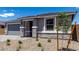 Charming single-story home featuring a gray exterior, stone accents, and well-maintained landscaping at 18714 E Panchito Dr, Gold Canyon, AZ 85118