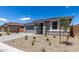 Attractive home with a gray exterior, stone veneer, and a paved driveway leading to an attached garage at 18714 E Panchito Dr, Gold Canyon, AZ 85118