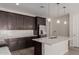 Bright kitchen featuring stainless steel appliances, white countertops, dark cabinets and pendant lighting at 18714 E Panchito Dr, Gold Canyon, AZ 85118