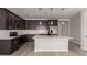 Contemporary kitchen showcases stainless steel appliances, white countertops, island and dark cabinets at 18714 E Panchito Dr, Gold Canyon, AZ 85118