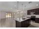 Open kitchen with an island, stainless steel appliances, dark cabinets and lots of natural light at 18714 E Panchito Dr, Gold Canyon, AZ 85118