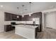 Modern kitchen featuring stainless steel appliances, dark cabinetry, and a large island at 18714 E Panchito Dr, Gold Canyon, AZ 85118