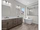 Elegant bathroom featuring a double vanity, a soaking tub, and a glass-enclosed shower at 1021 W Ridge Rd, Apache Junction, AZ 85120