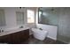 Modern bathroom with a standalone tub, double vanity, and glass-enclosed shower at 1021 W Ridge Rd, Apache Junction, AZ 85120